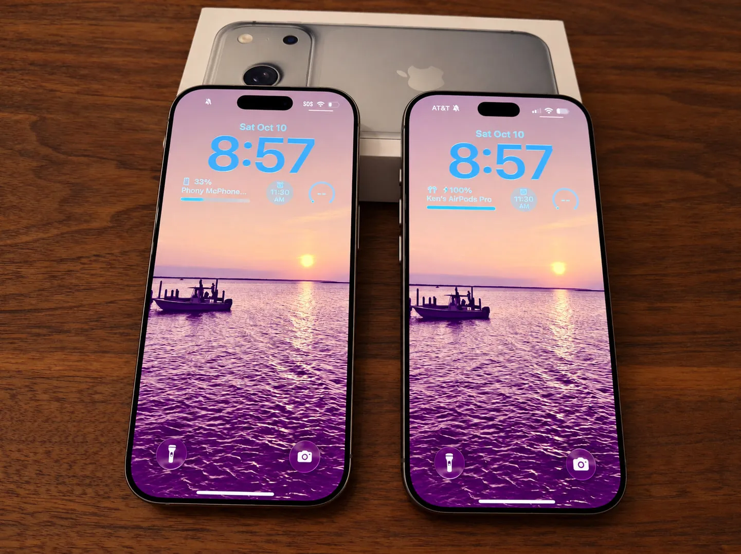 Two iPhones side by side on a table, with one displaying SOS and the other connected to AT&T.